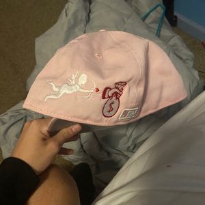 Atlanta braves pink fitted hat with stitch design.